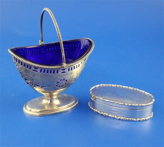 A late Victorian pierced silver boat shaped sugar basket with blue glass liner, 4in.